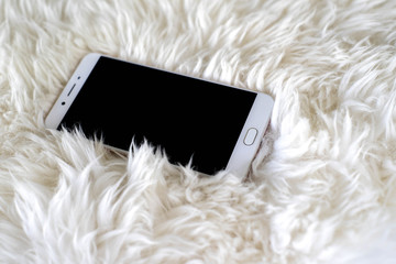 Smart phone on white carpet