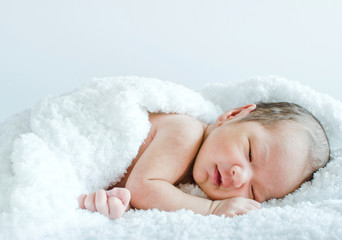 Newborn baby wrapped in a blanket in the hospital