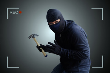 Camera capture and record caught Masked thief with hammer at night.