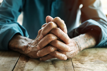 close up of elderly oldman hands on wooden table
