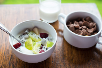 Breakfast, yogurt with fruit apples kiwi top view