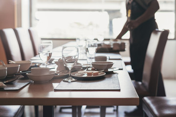 Empty dirty glasses and plates on dinning table in restaurant