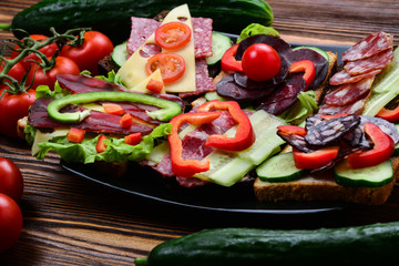 Sandwiches with different meat and vegetables.