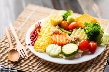 Vegetable salad with wooden spoon and fork, homemade and healthy food