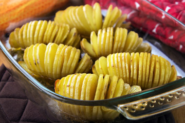 Hasselback potaoes in glass oven dish closeup