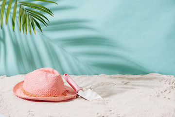 Sandy beach with towel, hat and summer accessories with copy space. Vacation and travel items. Tropical Holiday Background.
