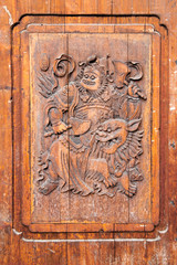 Traditional Chinese wooden door with martial art carving - fighting against devil with lions