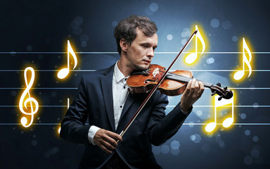 Young handsome fiddler playing with music sheet background