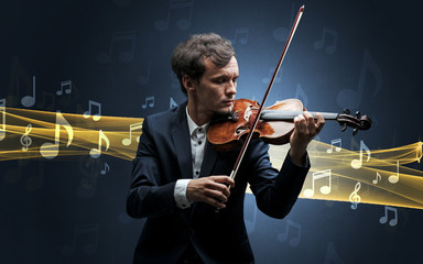 Fototapeta premium Young male musician playing on his violin with musical notes around