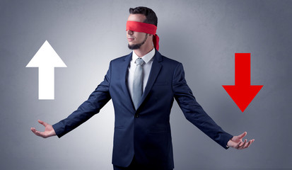 Covered eye businessman choosing between two directions 