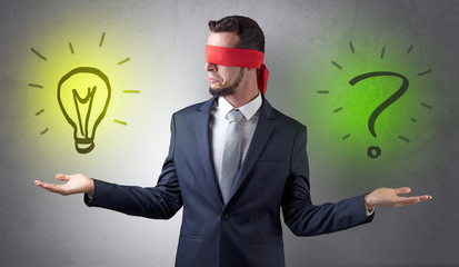 Covered eye businessman with bulb and question sign symbols around
