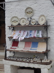 Shopfront display outside a whitewashed trullo building in Alberobello, Puglia, Italy