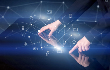 Male hands touching interactive table with blue mixed communication icons in the background