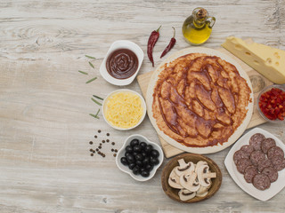 ingredients for pizza making on a wooden table. 