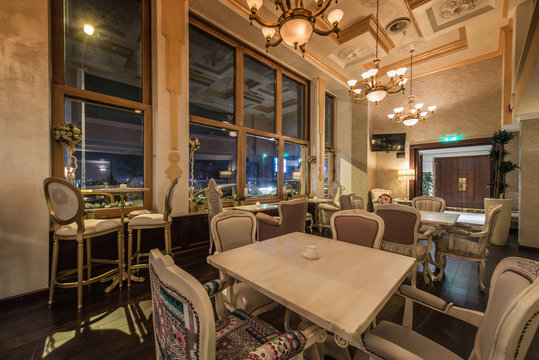 Restaurant interior with antique furniture and big classic chandeliers