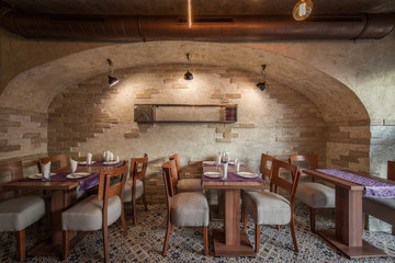 Brick wall and rustic tiled floor in restaurant interior