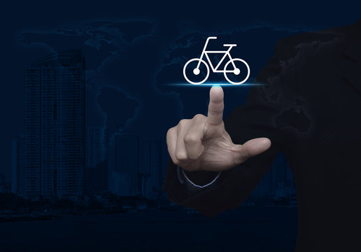 Businessman pressing bicycle flat icon over world map and modern city tower, Business service bike concept, Elements of this image furnished by NASA