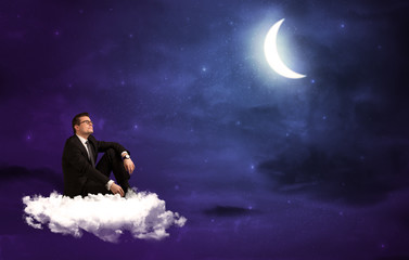Fototapeta na wymiar Caucasian businessman sitting on a cloud, wondering
