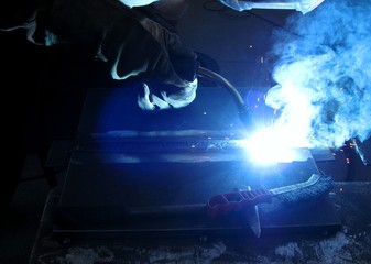 Example of correct position and posture and keeping the welding gun by an experienced welders - obrazy, fototapety, plakaty