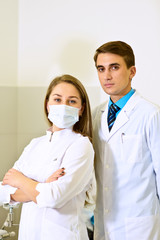 Doctors group. Portrait of surgeon and nurse standing with arms crossed in operation room at the hospital