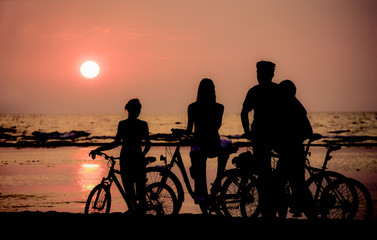 Fototapeta na wymiar Family rest on bicycles. Sunset. Contours. 