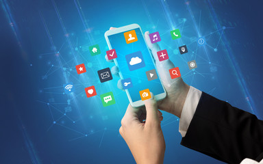 Female hand using smartphone with colorful application icons around