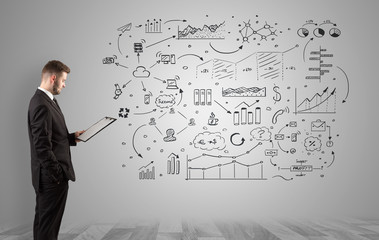 Manager staying and presenting office affairs for someone with graphs, icons reports around
