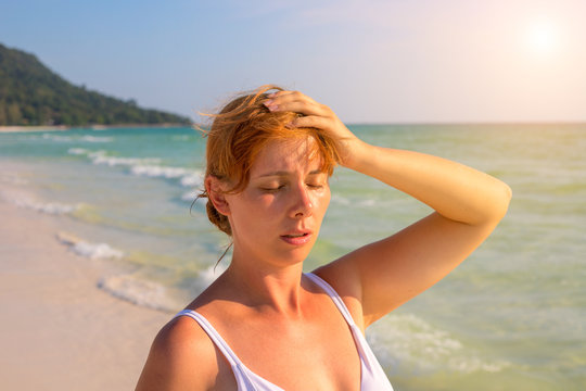 Woman Having Sun Stroke On Sunny Beach. Woman On Hot Beach With Sunstroke.