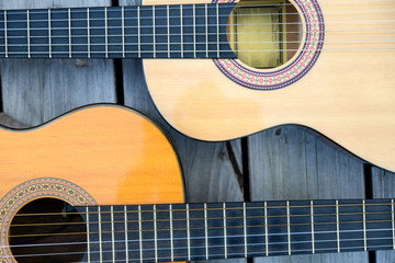 two acoustic guitar on wooden ground