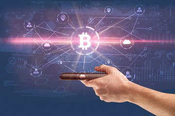 Hand using phone with cryptocurrency bitcoin link network and online concept
