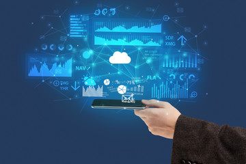 Businessman using phone with flying application icons around
