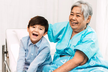 Obraz premium Portrait of happy elderly woman with little grandson smiling.relax family love people concept