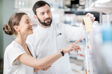 Pharmacist with client in the pharmacy store