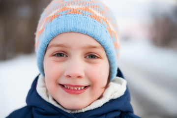 Little girl in   blue hat in winter.