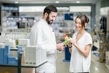 Pharmacist with client at the pharmacy store
