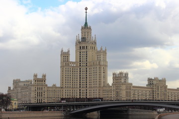 Fototapeta na wymiar Russia, Moscow, center - Stalin empire style, view from the embankment of the river on the skyscraper on Taganskaya square in the spring against the cloudy sky
