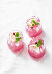 Pomegranate tequila cocktail. Summer light alcoholic drink,  cooling aperitif. On light background, top view, free space. Flat lay