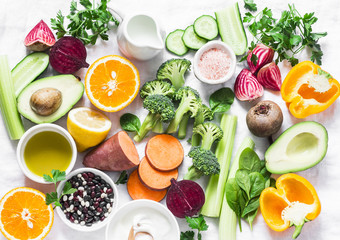 Five best vitamins for beautiful skin. Products with vitamins A, B, C, E, K - broccoli, sweet potatoes, orange, avocado, spinach, peppers, olive oil, dairy, beets, cucumber, beens. Flat lay, top view