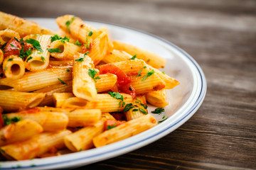 Penne with meat, tomato sauce and vegetables