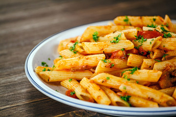 Penne with meat, tomato sauce and vegetables