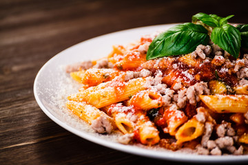 Penne with meat, tomato sauce and vegetables