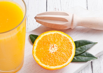 Fresh raw peeled oranges with hand juice squeezer