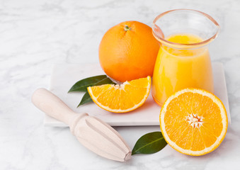 Fresh raw peeled oranges with hand juice squeezer