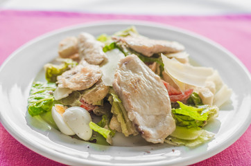 Cesar salad with roasted chicken meat