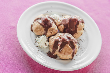 Mini chocolate cakes with chocolate icing, selective focus.