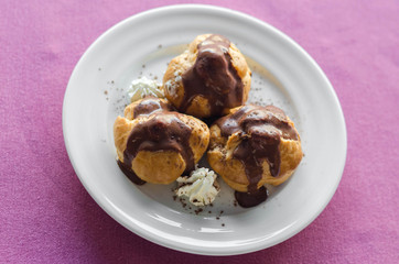 Mini chocolate cakes with chocolate icing, selective focus.