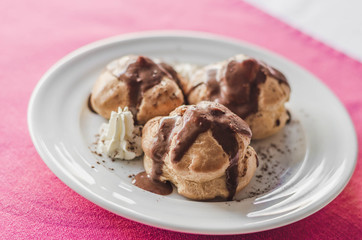 Mini chocolate cakes with chocolate icing, selective focus.