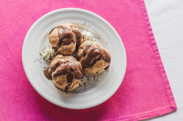 Mini chocolate cakes with chocolate icing, selective focus.