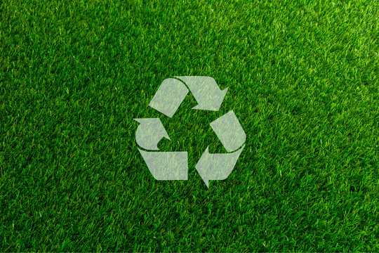 Recyclable Symbol a green on grass background