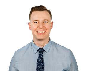 Portrait of young smiling businessman dressed in blue shirt and tie, isolated on white background